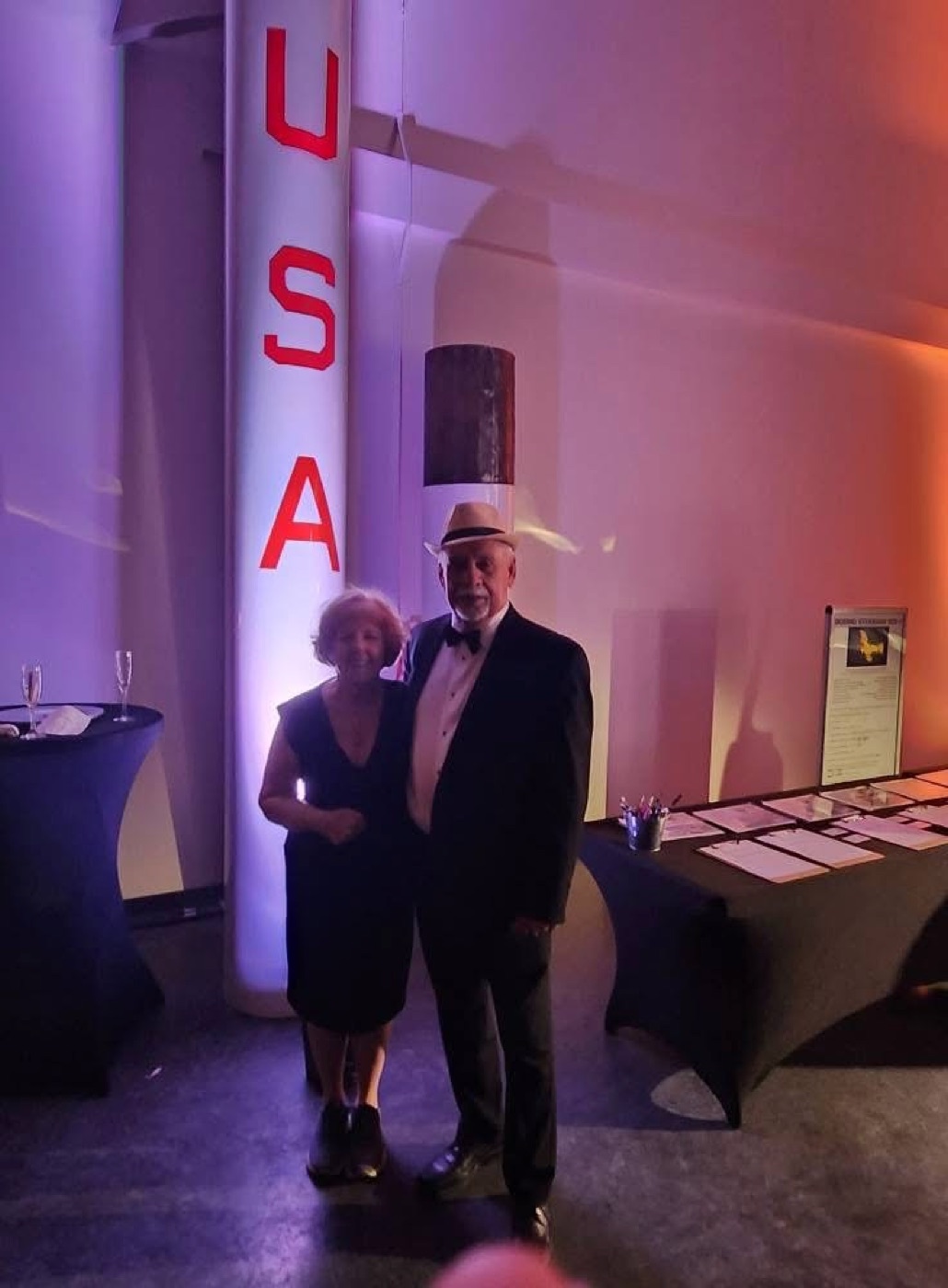 Larry and Denise in front of the illuminated USA rocket display